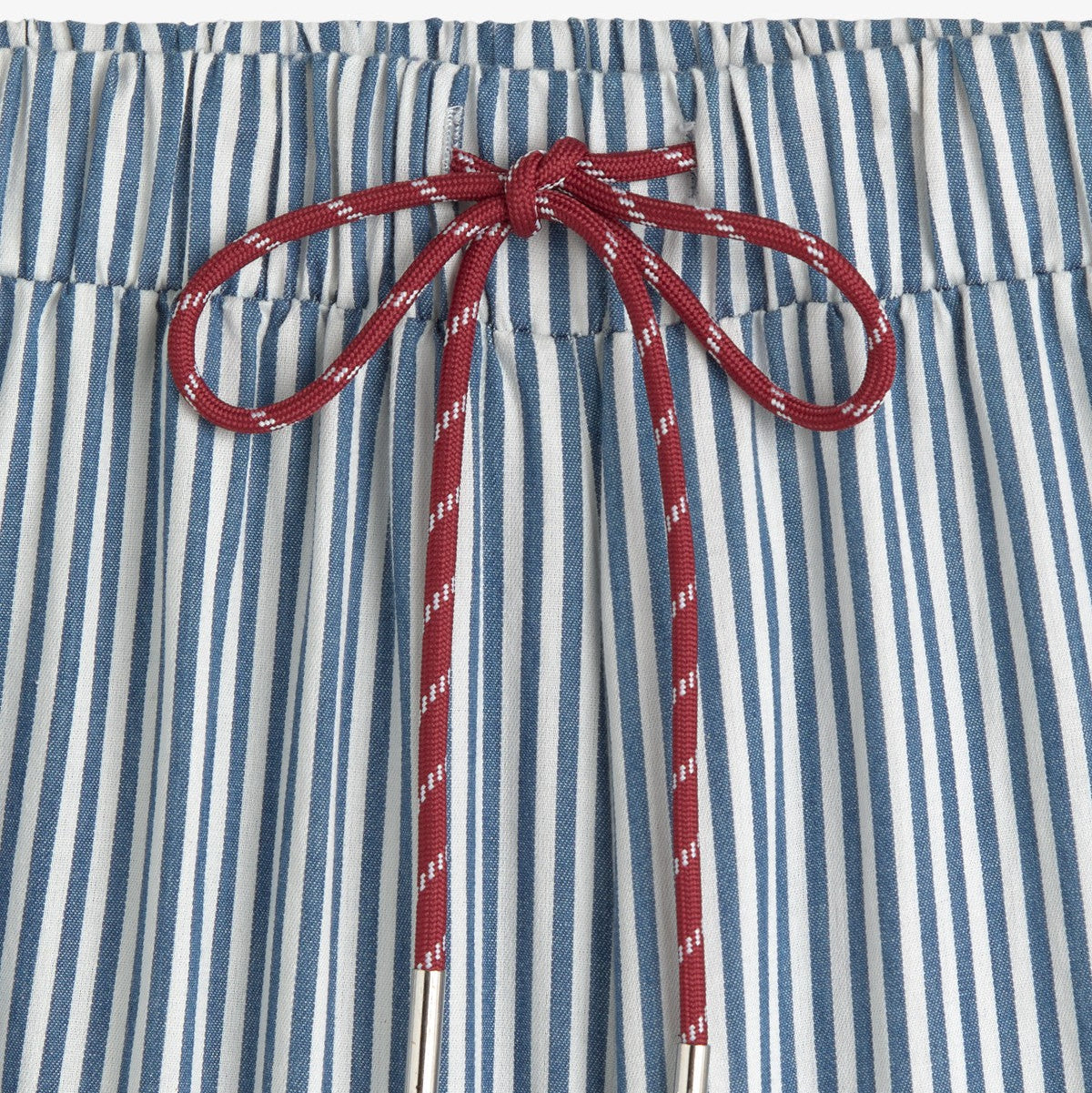 Blue and white striped pants with red drawstring on a white background