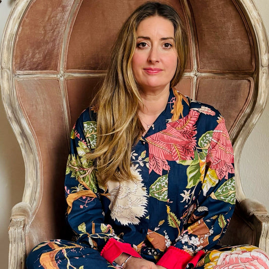 Woman in a floral dress sitting on an ornate chair