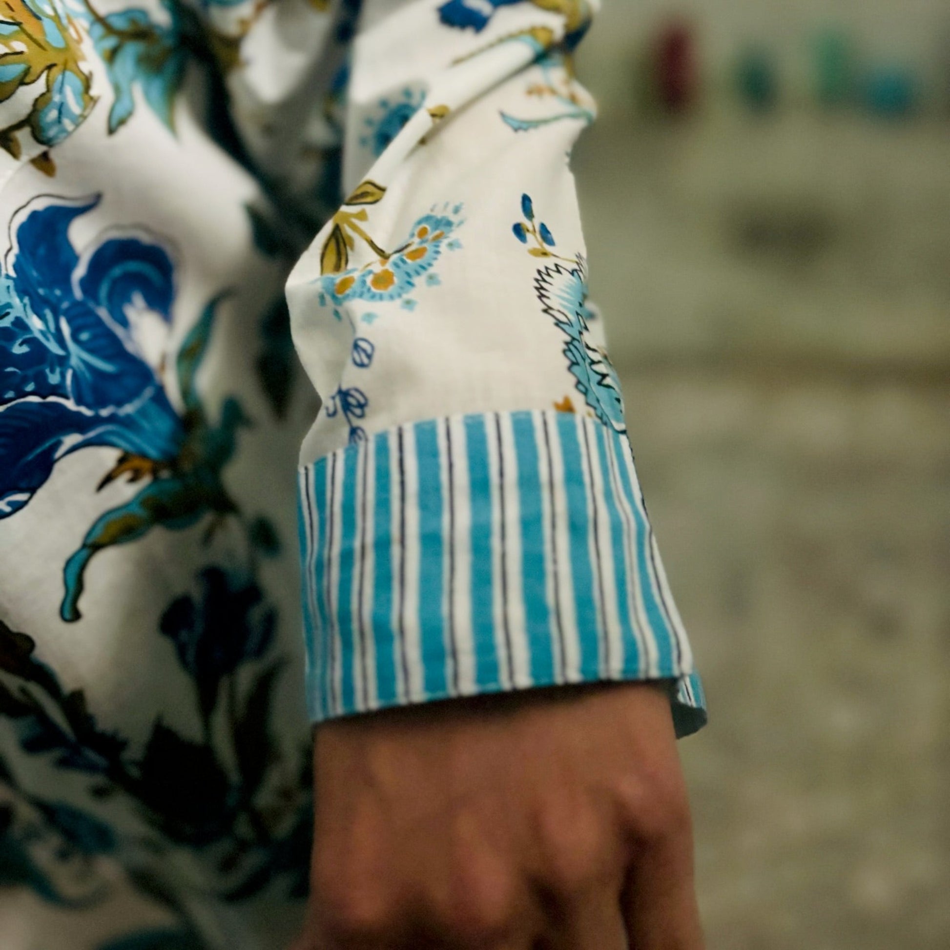 Close-up of a sleeve with floral and striped pattern on a blurred background