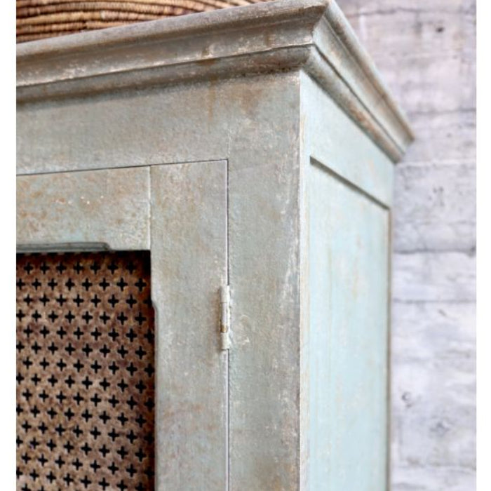 Decorative fireplace with lattice design and wicker basket on a stone wall background