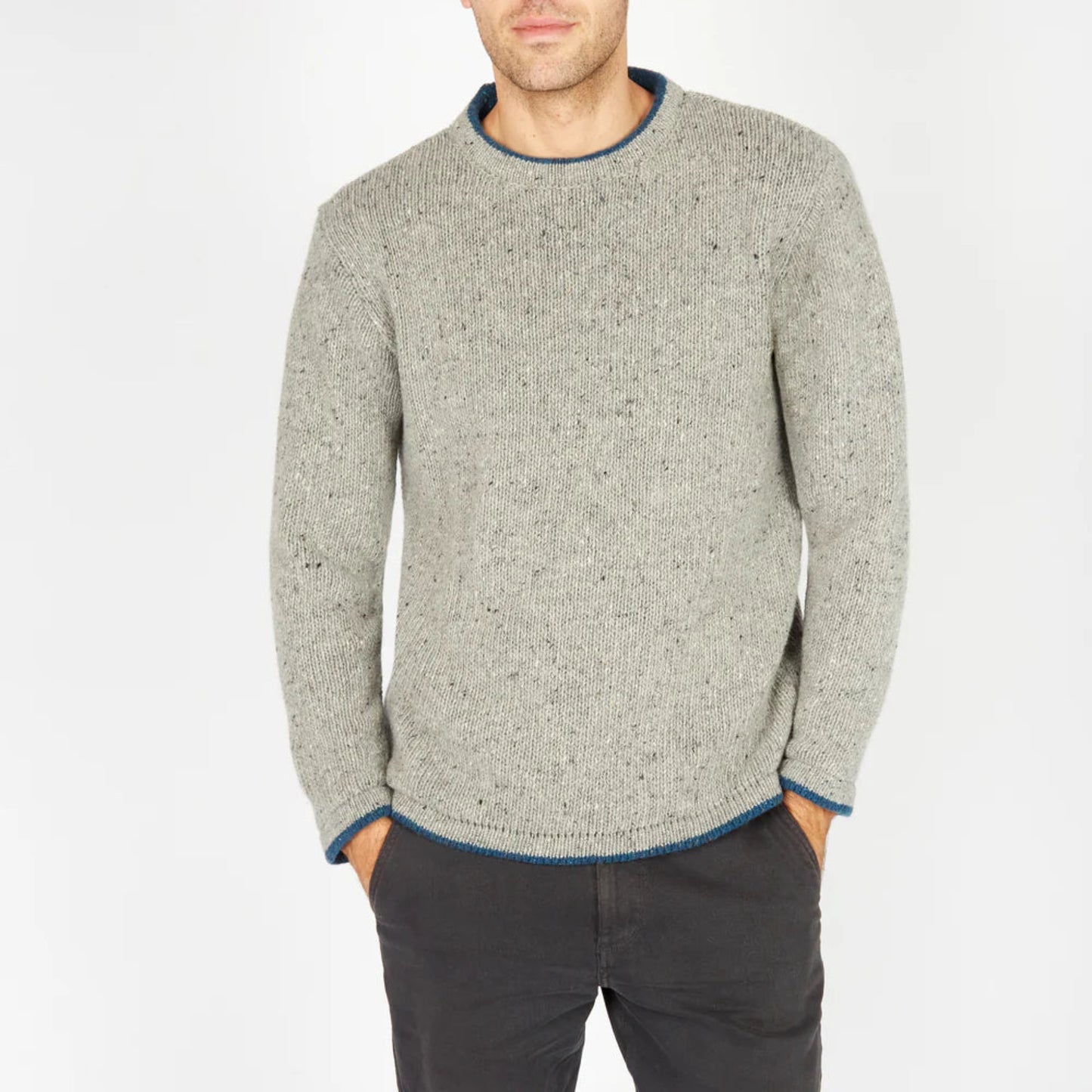 Man wearing a gray sweater with blue trim on a white background