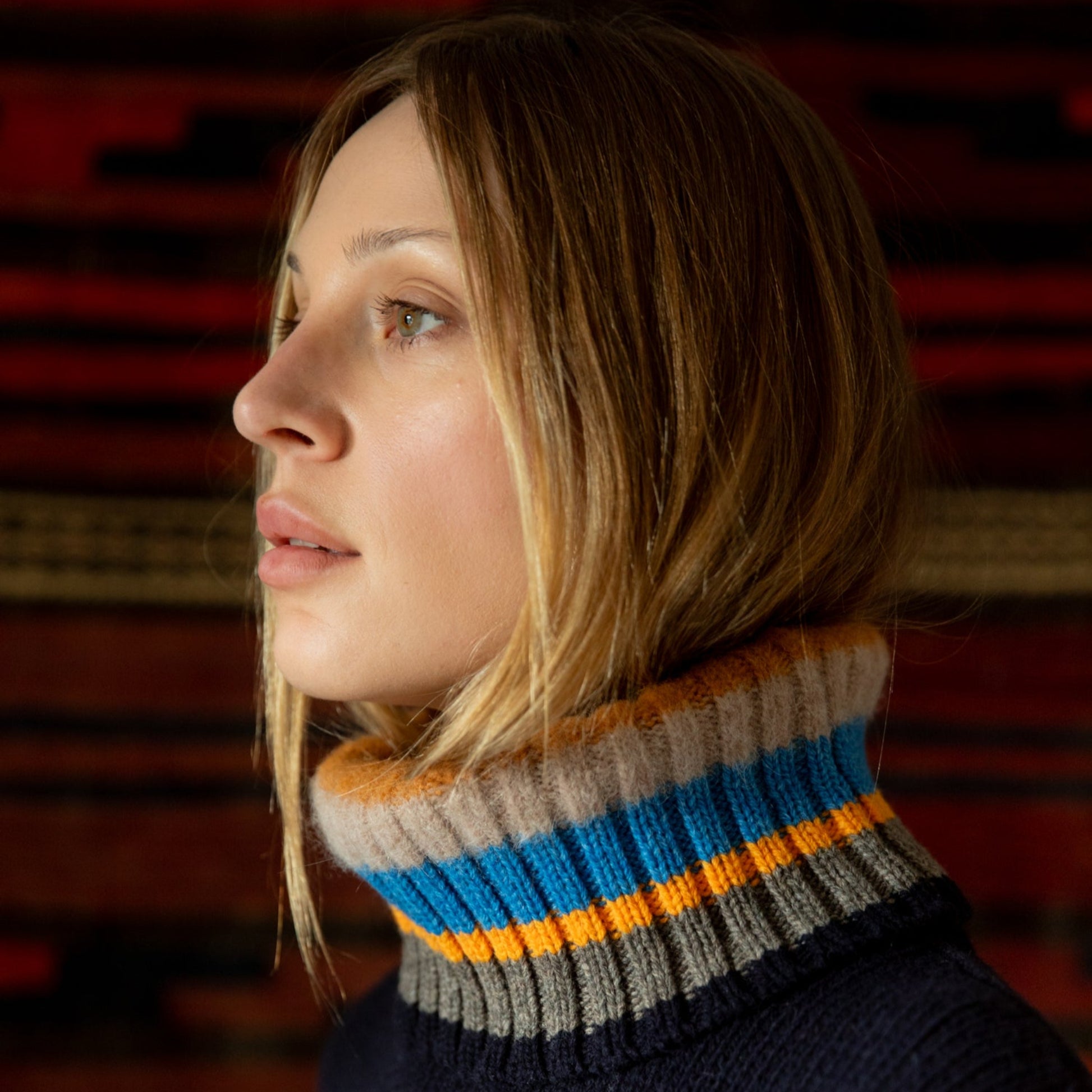 Woman wearing a striped sweater with a blurred background