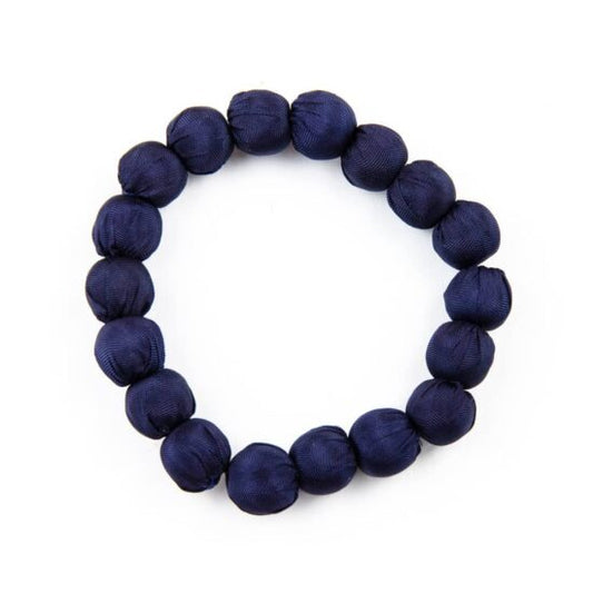 Navy blue beaded bracelet on a white background