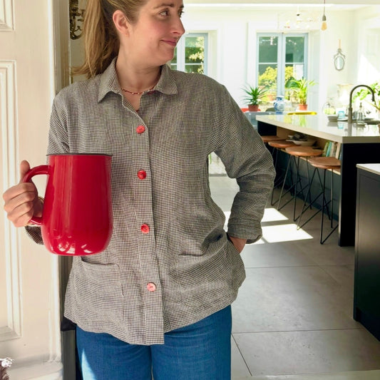 Woman holding a red mug in a modern kitchen