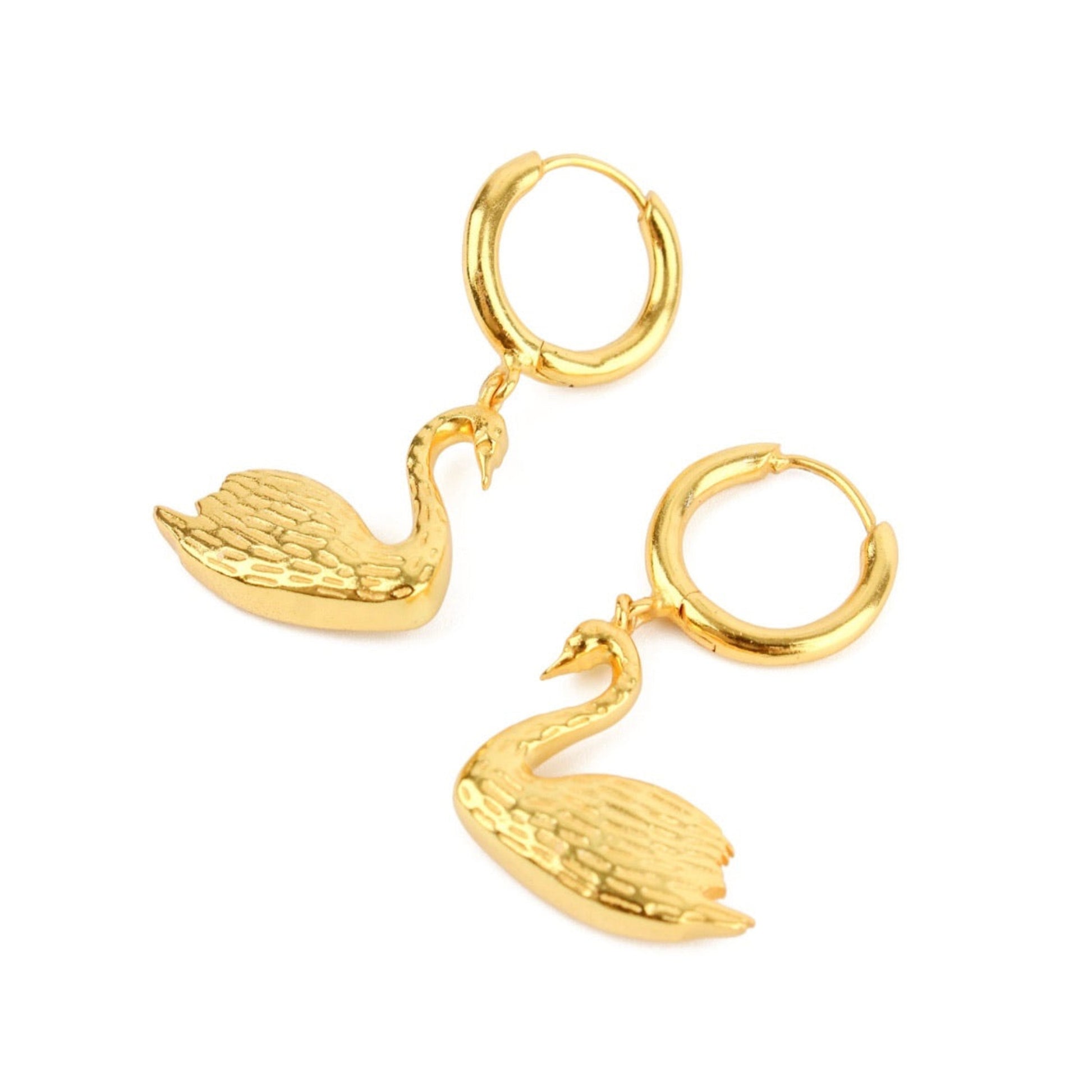 Gold hoop earrings with swan designs on a white background