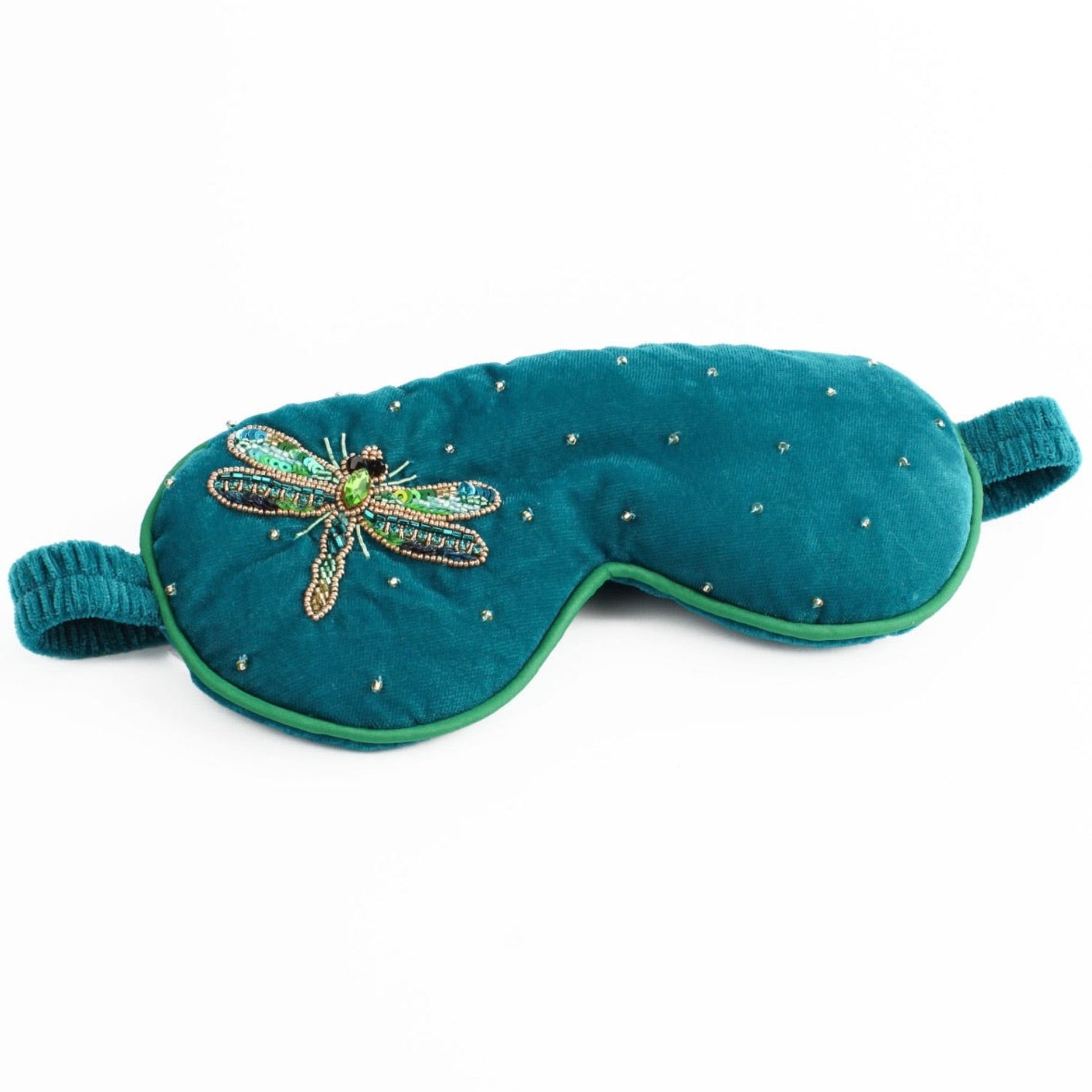 Teal eye mask with dragonfly design and bead details on a white background