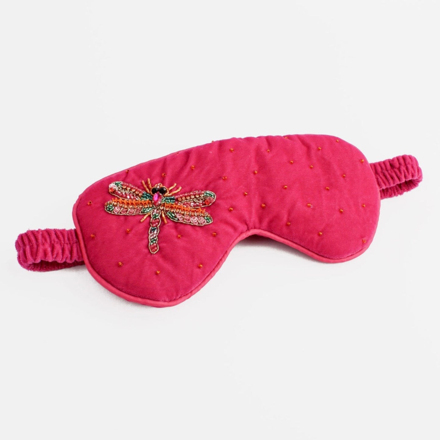 Pink eye mask with dragonfly design on a white background