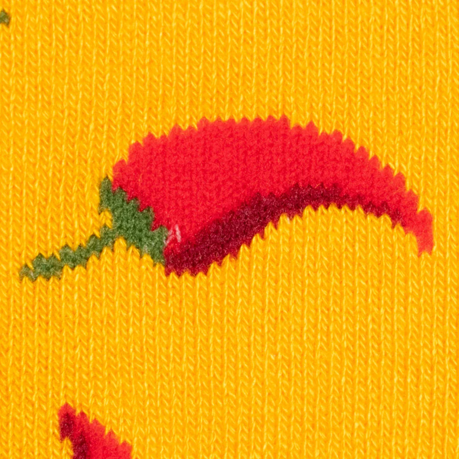 Red chili pepper design on yellow fabric