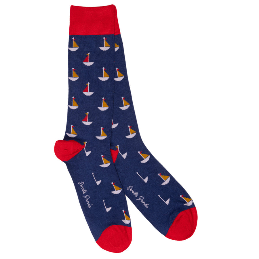 Navy blue sock with sailboat pattern and red accents on a white background