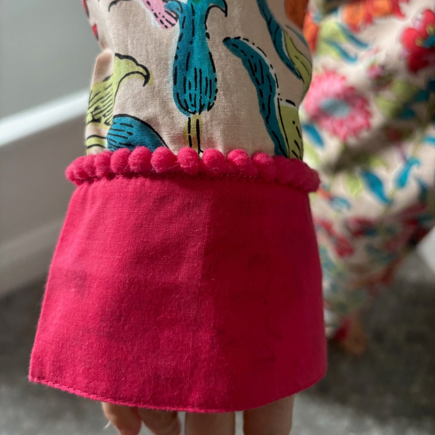 Colorful fabric with a red hem and underwater-themed pattern.