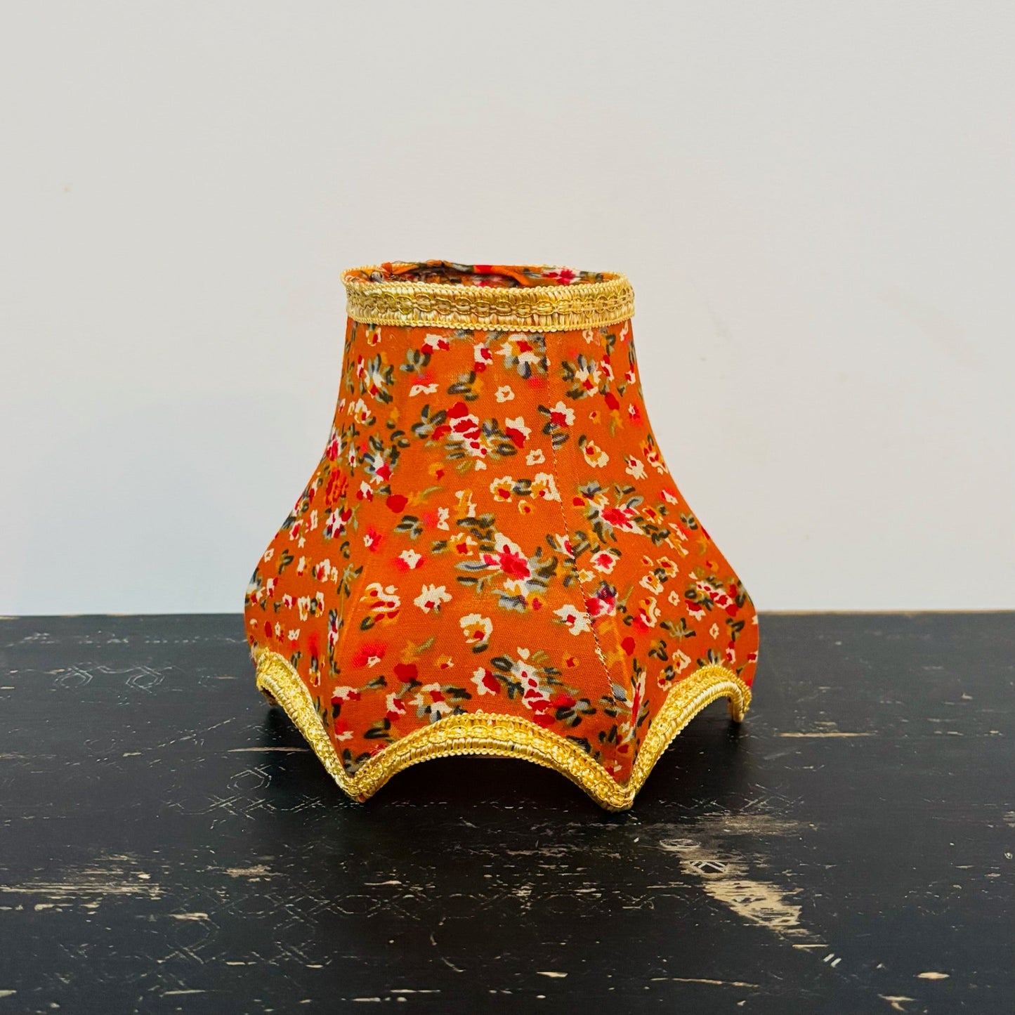 Decorative lampshade with floral pattern on a black surface