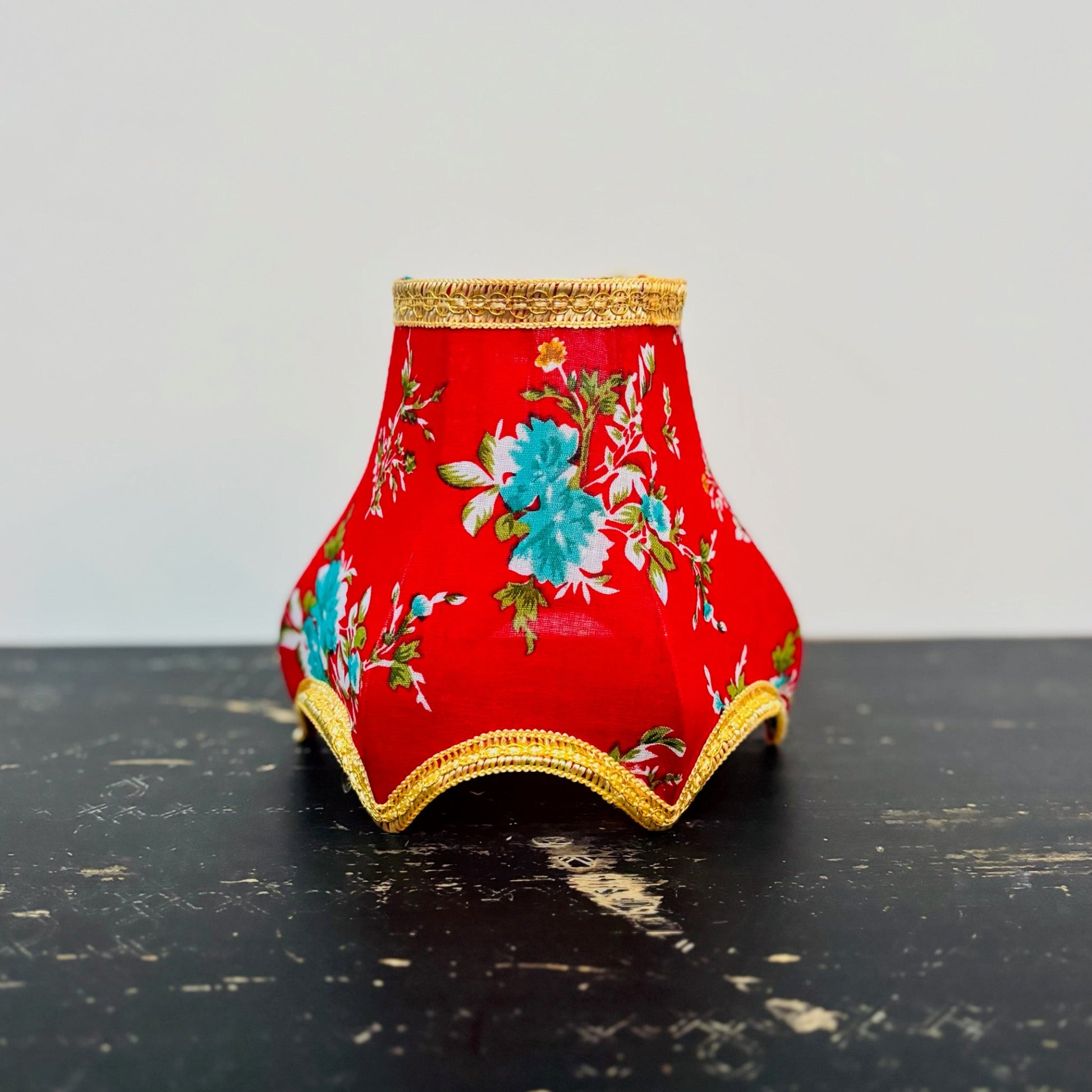 Decorative lampshade with floral pattern on a dark surface