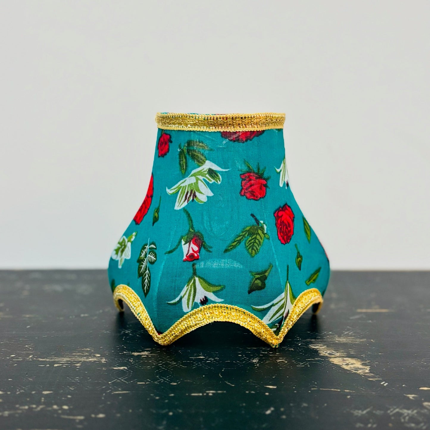 Decorative vase with floral pattern on a black surface