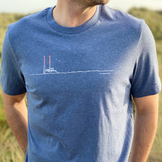 Person wearing a blue t-shirt with a graphic design outdoors