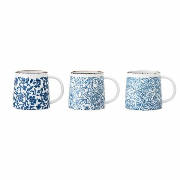 Three ceramic mugs with blue floral patterns on a white background