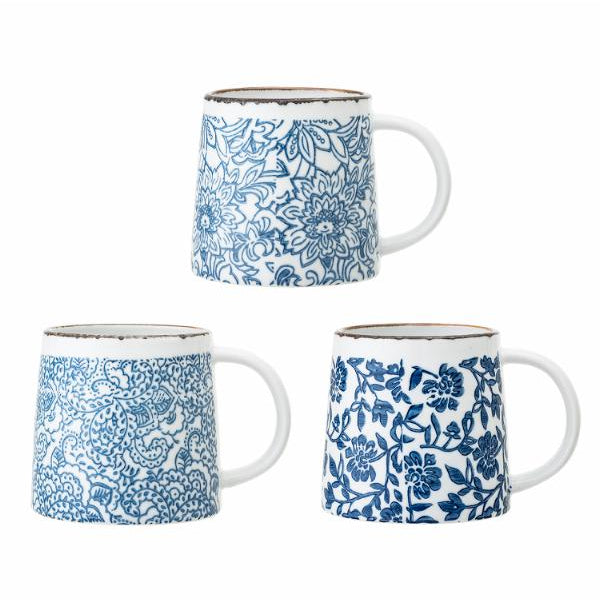 Set of three ceramic mugs with blue floral patterns on a white background